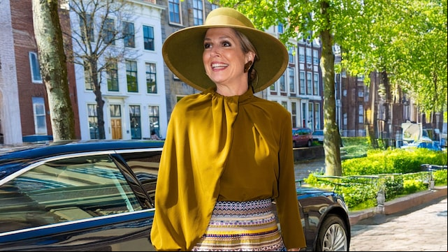La reina Máxima de Holanda con un look de invitada con falda estampada y sombrero