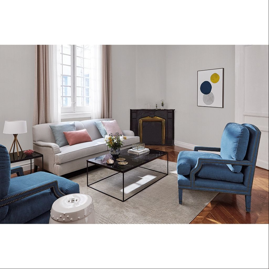 Salón con butaca azul y mesa de centro